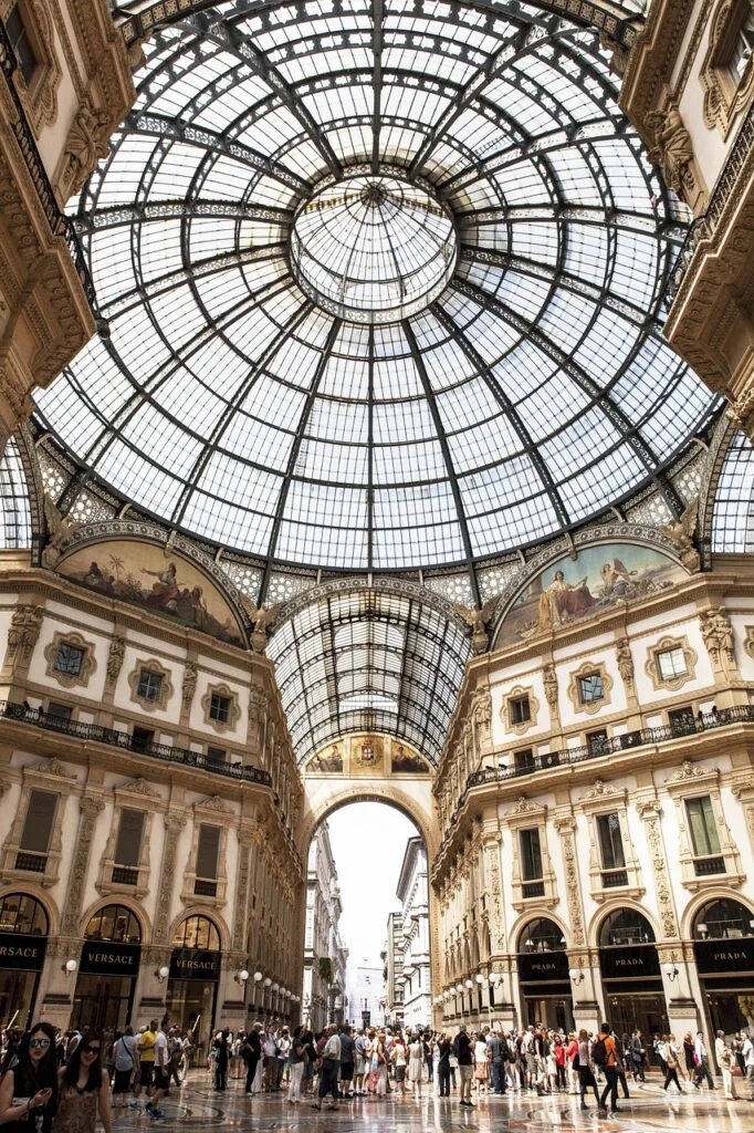 Drukke vloer onder glazen kruiskoepel van Galleria Vittorio Emanuele II, Milaan